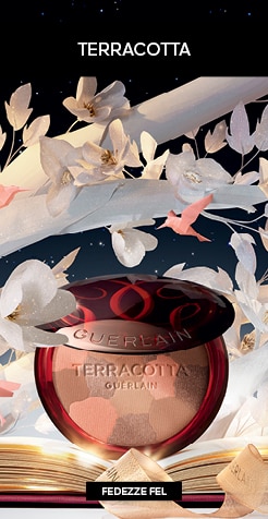 Guerlain Terracotta bronzosító elegáns piros tokban, papírvirág dekorációval és csillagos háttérrel.
